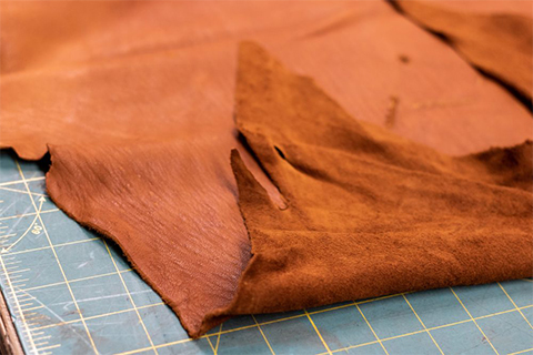 What is suede and the difficulty of dyeing process?
